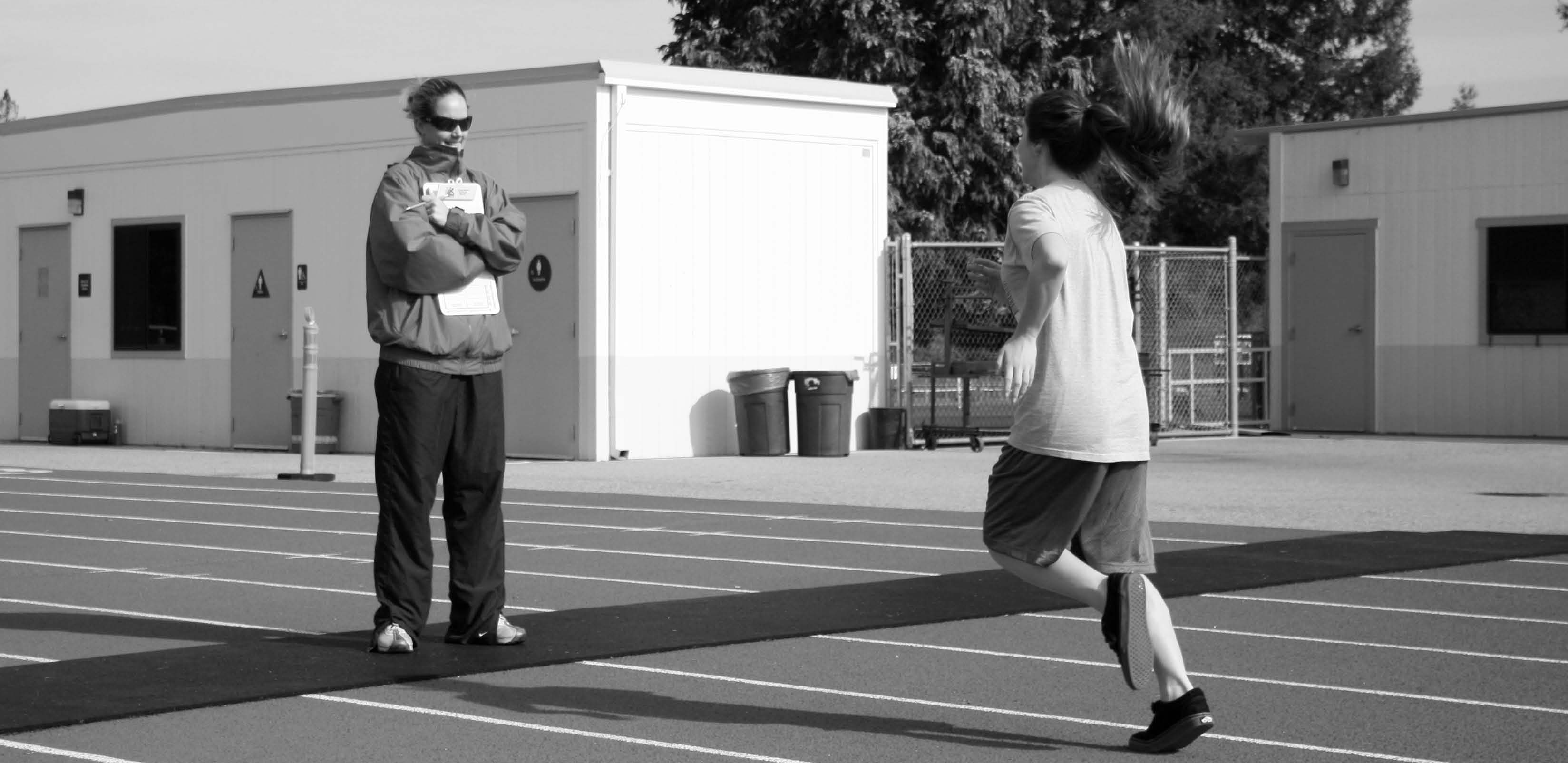 Freshman Rachel Norton runs a lap on the track during her PE makeup session with PE teacher Kiernan Raffo.
PE makeups are widely regarded as more strenuous than regular PE classes, an issue that should be rectified.