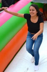 Junior Daniela Gomez runs down an inflatable. Photo by Ian Mackey. 